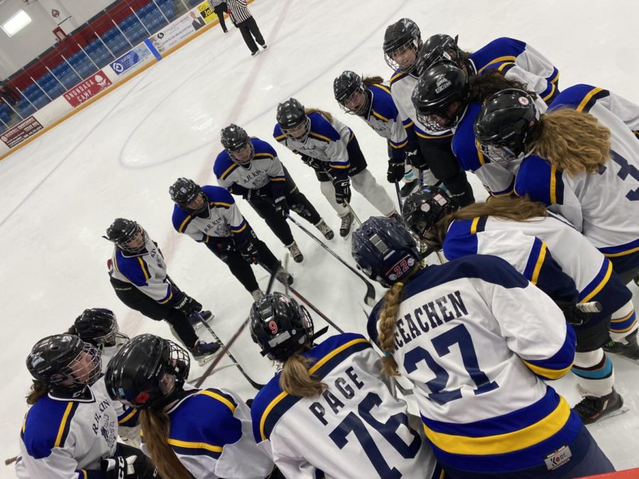 King hockey players standing in a circle before the final game